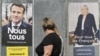 Žena hoda ispred predizbornih plakata Emanuela Makrona i Marin le Pen, pred predsedničke izbore u Franuskoj.