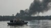 FILE: A cloud of smoke rises from an illegal oil refinery on April 19, 2017 in the Niger Delta region near the city of Port Harcourt. 