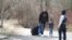 Asylum seekers cross into Canada from the U.S. border near a checkpoint on Roxham Road near Hemmingford, Quebec, April 24, 2022. 