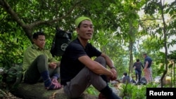 Nguyen Ngoc Anh, 36, who was an illegal logger turned forest protector poses at Phong Nha National Park, Quang Binh province, Vietnam, April 8, 2022. 