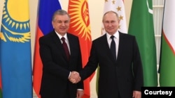 Russian leader Vladimir Putin shakes hands with Uzbek President Shavkat Mirziyoyev in St. Petersburg, Russia, during the informal meeting of the Commonwealth of Independent States, Dec. 28, 2021. (kremlin.ru) 