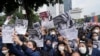 Students hold posters with portraits of President Joko Widodo during a rally in Jakarta, Indonesia, Thursday, April 21. 2022. 