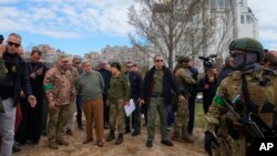 UN Secretary-General Antonio Guterres, fourth left, is seen visiting Bucha, on the outskirts of Kyiv, Ukraine, on April 28, 2022.