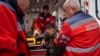 Ambulance workers help an injured Ukrainian serviceman to move to a hospital in Donetsk region, eastern Ukraine, April 23, 2022. 