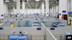 In this photo released by China's Xinhua News Agency, patient beds are seen at a makeshift hospital in Shanghai, China, April 21, 2022. 