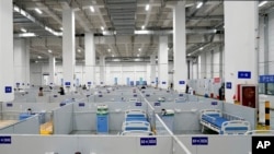 In this photo released by China's Xinhua News Agency, patient beds are seen at a makeshift hospital in Shanghai, China, April 21, 2022. 