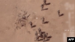 FILE - This screen grab from video obtained April 22, 2022, from the French army, which claims to have filmed it via drone, reportedly shows Russian mercenaries burying bodies near a base in Gossi, northern Mali.