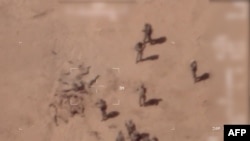 This screen grab from a video obtained from the French army on April 22, 2022, which claims to have filmed it via a drone, shows, according to them, Russian mercenaries burying bodies near a base in Gossi, northern Mali.