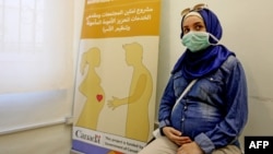 FILE - A Lebanese mother-to-be waits for her turn at a clinic providing free consultations in Beirut, Lebanon, Sept. 18, 2020.