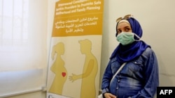 FILE - A Lebanese mother-to-be waits for her turn at a clinic providing free consultations in Beirut, Lebanon, Sept. 18, 2020.
