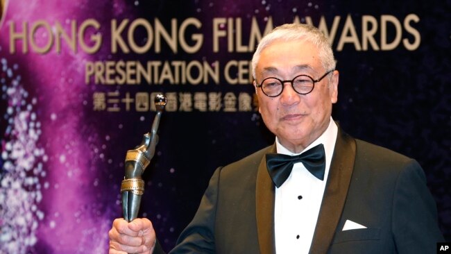 FILE - Hong Kong actor Kenneth Tsang poses after winning the Best Supporting Actor award for his movie 'Overhead 3' during the Hong Kong Film Awards in Hong Kong, Apr. 19, 2015.