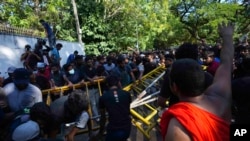 Sri Lankan university students push down police barricades during a protest over the country’s worst economic crisis in decades outside the residence of prime minister Mahinda Rajapaksa in Colombo, Sri Lanka, April 24, 2022.