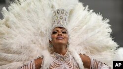 FILE - A dancer from the Academicos do Tucuruvi samba school performs during a carnival parade in Sao Paulo, Brazil, April 22, 2022.