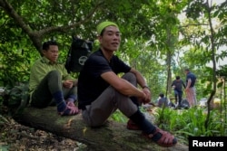 Nguyen Ngoc Anh, 36, who was an illegal logger turned forest protector poses at Phong Nha National Park, Quang Binh province, April 8, 2022. (REUTERS/Hoang Trung)