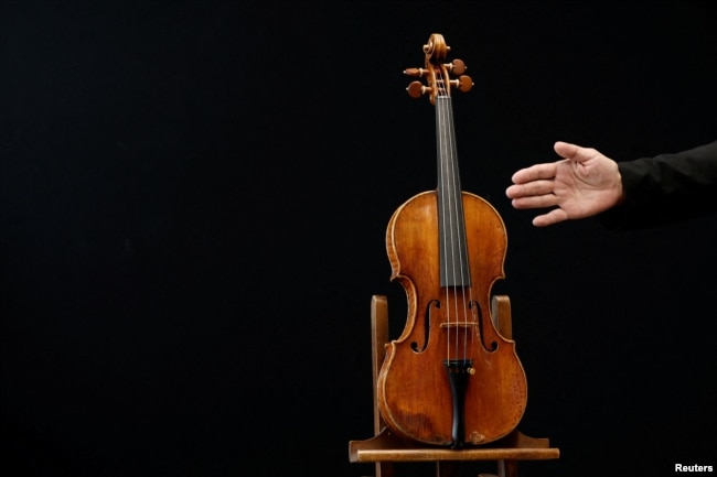 A rare 1736 violin by Italian luthier Guarneri del Gesu is displayed during a media preview at Aguttes auction house ahead of the violin's auction in Neuilly-sur-Seine, near Paris, France, April 26, 2022. (REUTERS/Benoit Tessier)