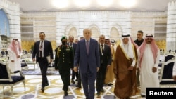 Turkish President Tayyip Erdogan walks alongside Mecca Governor Prince Khaled al-Faisal as he arrives at King Abdulaziz International Airport in Jeddah, Saudi Arabia, April 28, 2022.