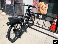 A delivery bicycle is parked in front of Gorillas mini-warehouse in the Williamsburg section of the Brooklyn borough of New York on Monday, April 12, 2022. (AP Photo/Tali Arbel)