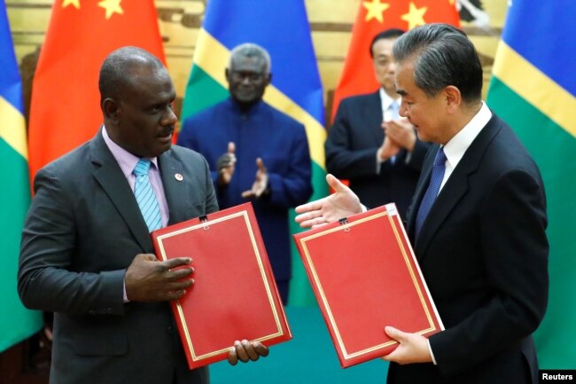 Penasihat Negara dan Menteri Luar Negeri China Wang Yi dan Menteri Luar Negeri Kepulauan Solomon Jeremiah Manele menghadiri upacara penandatanganan di Aula Besar Rakyat di Beijing, China, 9 Oktober 2019. (Foto: Reuters)