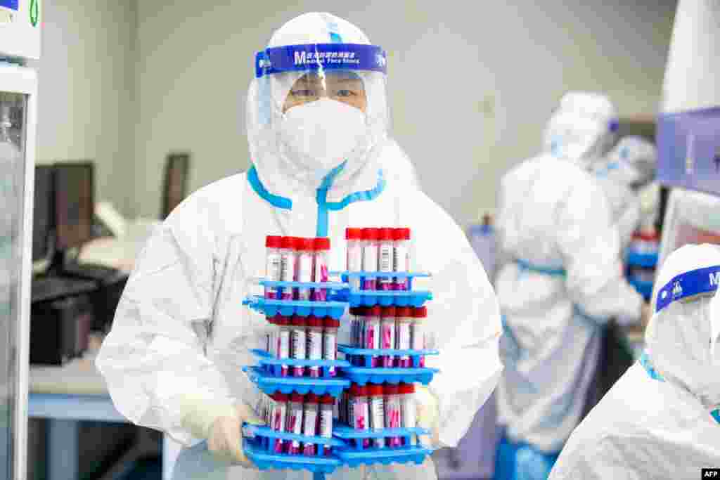 A laboratory technician wearing personal protective equipment (PPE) works at a Covid-19 testing laboratory in Haian in China&#39;s eastern Jiangsu province, China.