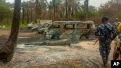 People gather at the site of an explosion at an illegal oil bunkering site in the Egbema local government area, Imo state, in southeastern Nigeria, April 24, 2022. 