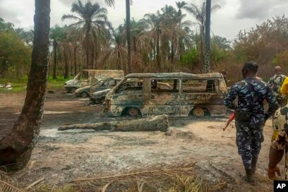 FILE - People gather at the site of an explosion at an illegal oil bunkering site in the Egbema local government area, Imo state, in southeastern Nigeria, April 24, 2022.
