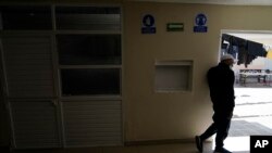 FILE - A man waits at a migrant shelter in Tijuana, Mexico, April 21, 2022. A Trump-era policy forces asylum-seekers to wait in Mexico for hearings in U.S. immigration court.