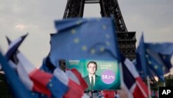 Pendukung Presiden Prancis Emmanuel Macron merayakan laporan kemenangannya di Paris, Minggu, 24 April 2022 . (AP/Lewis Joly)
