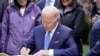 President Joe Biden signs an executive order intended to help restore national forests devastated by wildfires, drought and blight, during an event at Seward Park on Earth Day, April 22, 2022, in Seattle.