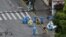 Health workers in protective suits walk along a street during a COVID-19 lockdown in the Jing'an district of Shanghai, China, April 24, 2022.