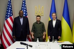 Ukraine's President Volodymyr Zelenskiyy, center, poses for a picture with U.S. Defense Secretary Lloyd Austin, left, and U.S. Secretary of State Antony Blinken before a meeting in Kyiv, Ukraine April 24, 2022.