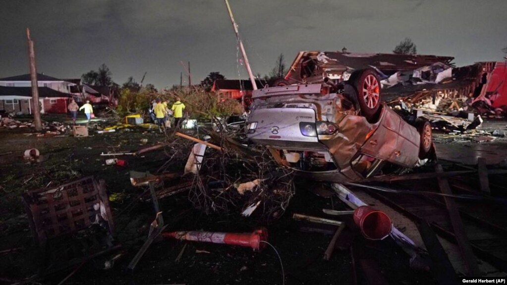 FILE - A car is flipped over after a tornado tore through the area in Arabi, Louisiana on March 22, 2022, in a part of the city that had been heavily damaged by Hurricane Katrina 17 years earlier. (AP Photo/Gerald Herbert, File)