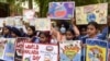 Students hold placards during an event to mark the World Malaria Day at a government hospital on the outskirts of Amritsar in India on April 25, 2022. 