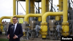 Poland's Prime Minister Mateusz Morawiecki speaks during a news conference near the gas installation at a Gaz-System gas compressor station in Rembelszczyzna, outside Warsaw, Poland, April 27, 2022. 