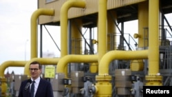 Poland's Prime Minister Mateusz Morawiecki speaks during a news conference near the gas installation at a Gaz-System gas compressor station in Rembelszczyzna, outside Warsaw, Poland, April 27, 2022. 