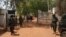 FILE - Nigerian soldiers and police officers stand at the entrance of a school in Kaduna state, on March 12, 2021, after a mass abduction. Family members report that on March 7, 2024, dozens of students were kidnapped from a school in the town of Kuriga. 