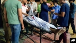 The body of Ibris Khan, 28, who went missing on April 10 during violence in Khargone and found a week later, is carried on a stretcher outside a mortuary in Indore, the central Indian state of Madhya Pradesh, April 18, 2022.