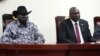 FILE - South Sudanese President Salva Kiir, left, and opposition leader Riek Machar attend the signing ceremony after the two leaders sealed an agreement on a key military provision of their faltering peace deal at the state house in Juba, April 3, 2022.