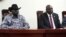 FILE - South Sudanese President Salva Kiir, left, and opposition leader Riek Machar attend the signing ceremony after the two leaders sealed an agreement on a key military provision of their faltering peace deal at the state house in Juba, April 3, 2022.