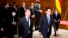 German Chancellor Olaf Scholz, left, and his Japanese counterpart Fumio Kishida walk together after viewing an honor guard ahead of their bilateral meeting at the prime minister's office in Tokyo, April 28, 2022. 