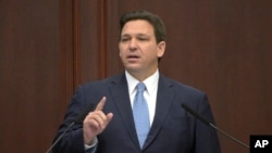 FILE - Florida Gov. Ron DeSantis addresses a joint legislative session, in Tallahassee, Florida, Jan. 11, 2022.