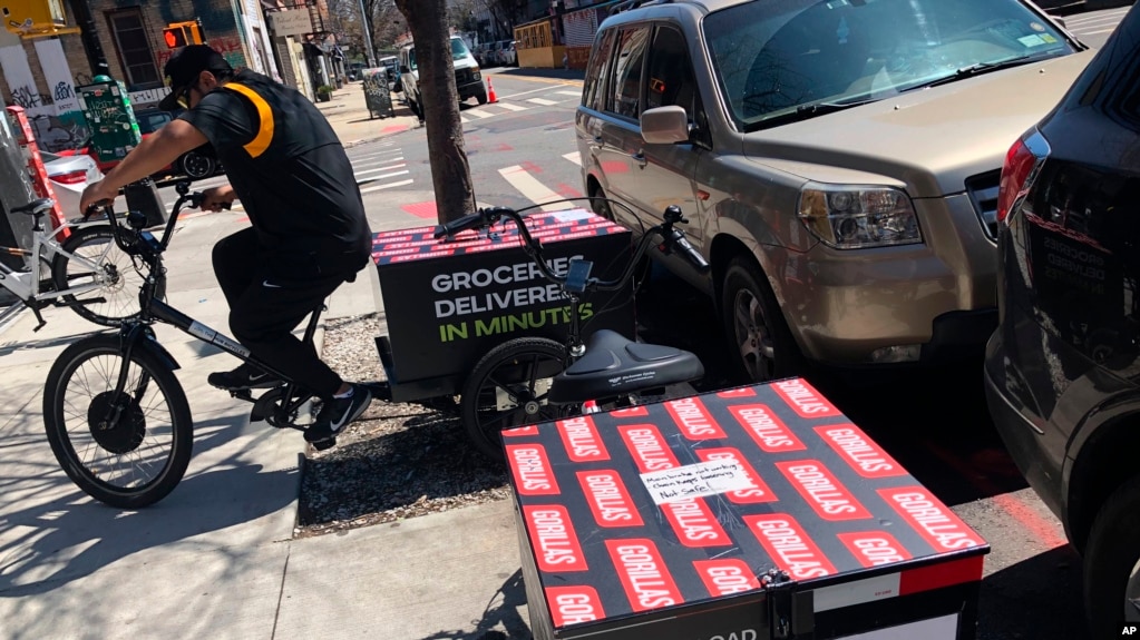 A worker sets to make a delivery on a bicycle in front of Gorillas mini-warehouse in the Williamsburg section of the Brooklyn borough of New York on Monday, April 12, 2022. (AP Photo/Tali Arbel)