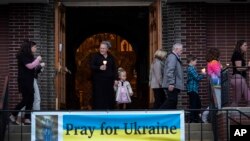 Parishioners walk in procession around the church during a Good Friday service at St. Mary's Ukrainian Orthodox Cathedral in Allentown, Pa., April 22, 2022.