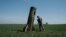 A Ukrainian serviceman looks at a Russian ballistic missile's booster stage that fell in a field in Bohodarove, eastern Ukraine, on April 25, 2022, amid the Russian invasion of Ukraine. 