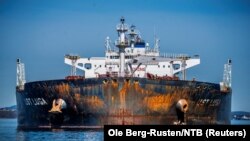 Members of Greenpeace sail next to a tanker "Ust Luga" as part of a protest against delivering Russian oil to Norway, amid Russia's invasion of Ukraine, according to Greenpeace, near Asgardstrand, Norway, April 25, 2022.