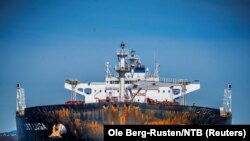 Members of Greenpeace sail next to a tanker "Ust Luga" as part of a protest against delivering Russian oil to Norway, amid Russia's invasion of Ukraine, according to Greenpeace, near Asgardstrand, Norway, April 25, 2022.