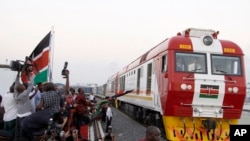 FILE - A Standard Gauge Railway cargo train rides from the port container depot on a Chinese-backed railway costing nearly $3.3 billion, opened by Kenya's president as one of the country's largest infrastructure projects since independence, in Mombasa, Kenya, May 30, 2017.