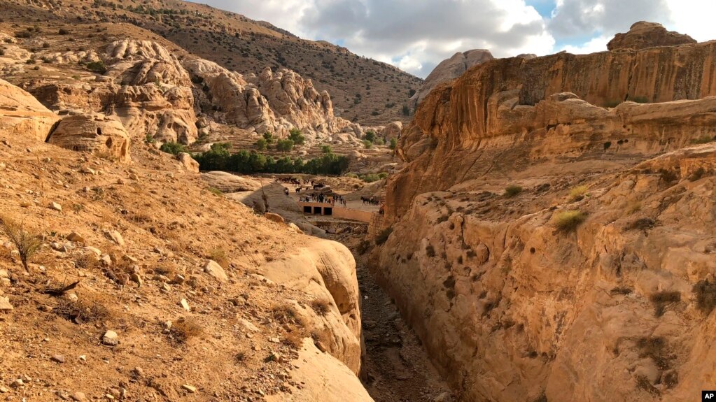 This file photo shows where a dam was built in the 1960's by the Department of Antiquities, and the ancient Mudlim tunnel, both built to protect the area from flooding, in Petra, Jordan, Nov. 15, 2018. (AP Photo/Laure Van Ruymbeke, file)