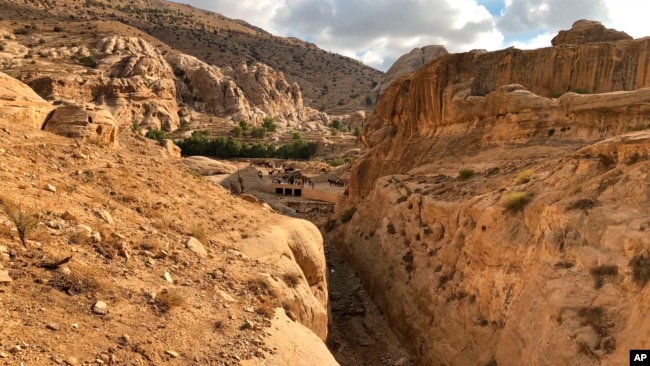 This file photo shows where a dam was built in the 1960's by the Department of Antiquities, and the ancient Mudlim tunnel, both built to protect the area from flooding, in Petra, Jordan, Nov. 15, 2018. (AP Photo/Laure Van Ruymbeke, file)