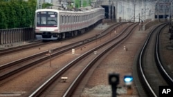 Trains run near Tokyu Railways' Tamagawa Station, April 20, 2022, in Tokyo, Japan.