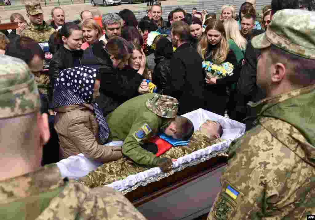 Relatives and friends pay their last respects during the funeral of Ukrainian serviceman Oleh Skybyk, killed during Russia's invasion of Ukraine, at Lychakiv cemetery in the western Ukrainian city of Lviv.
